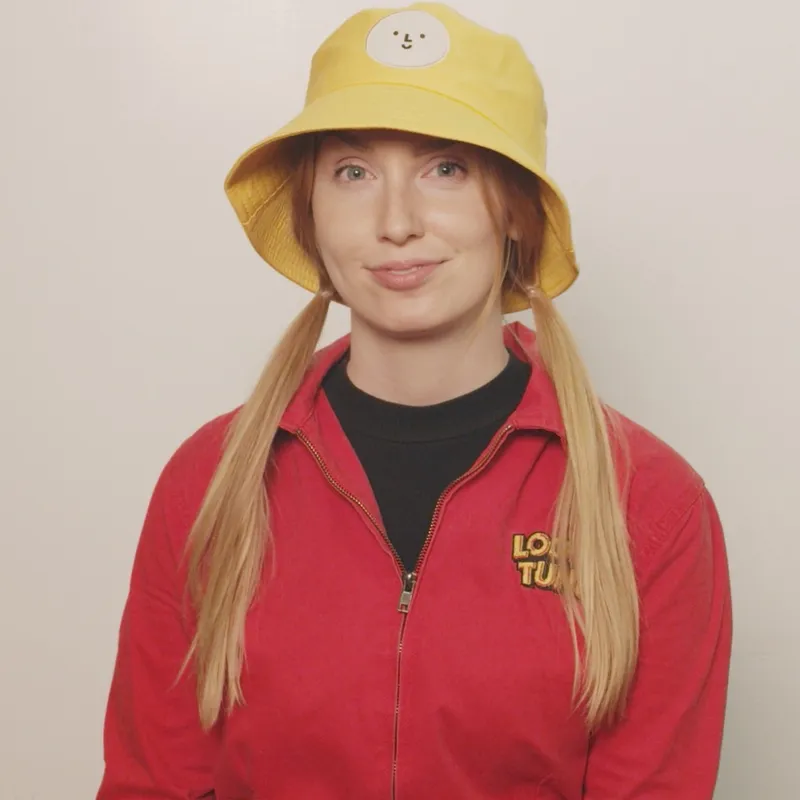 Kami Karras: portrait in a yellow bucket hat